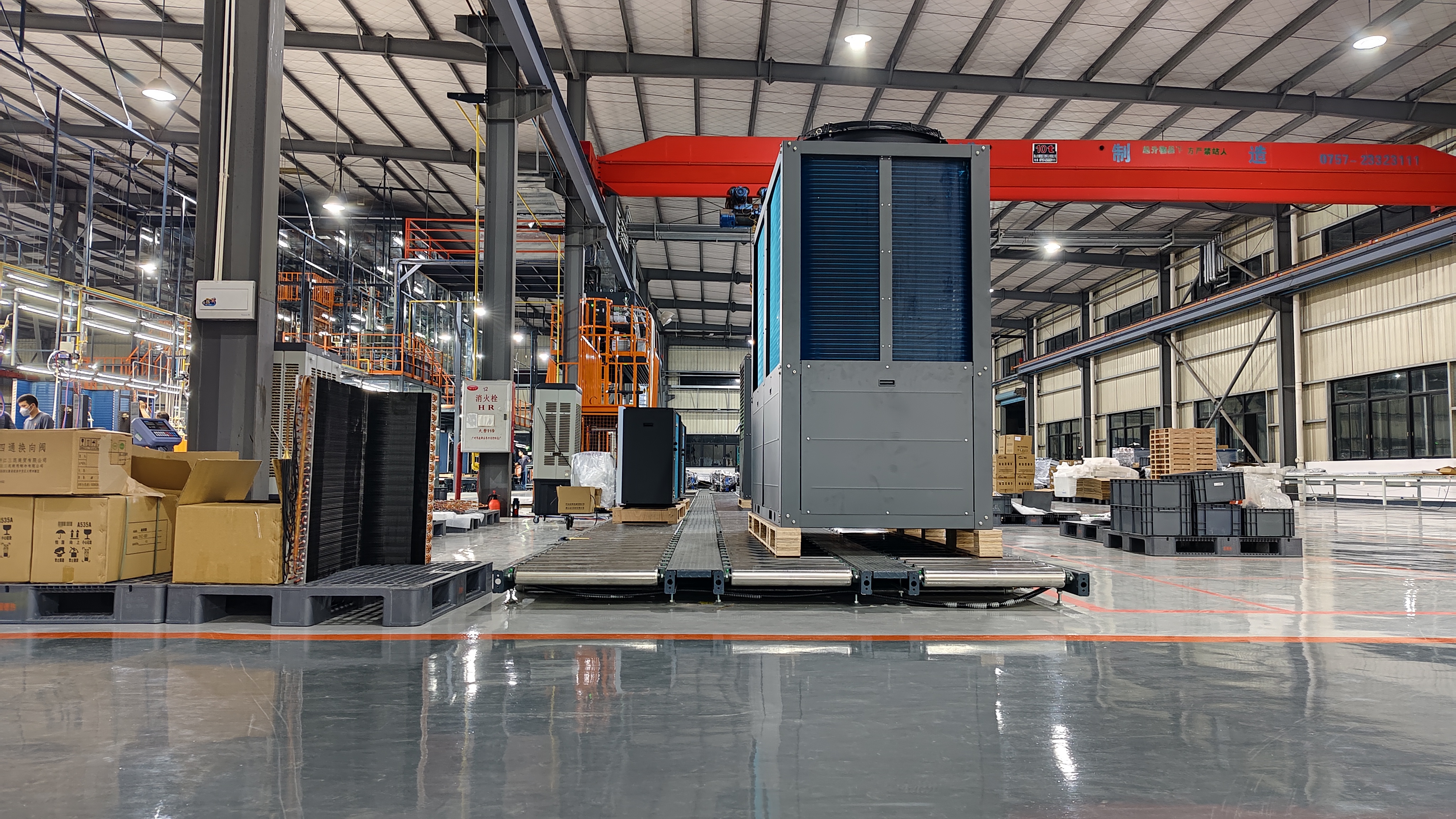 Commercial heat pump unit on a roller conveyor at GOODHEAT’s manufacturing facility