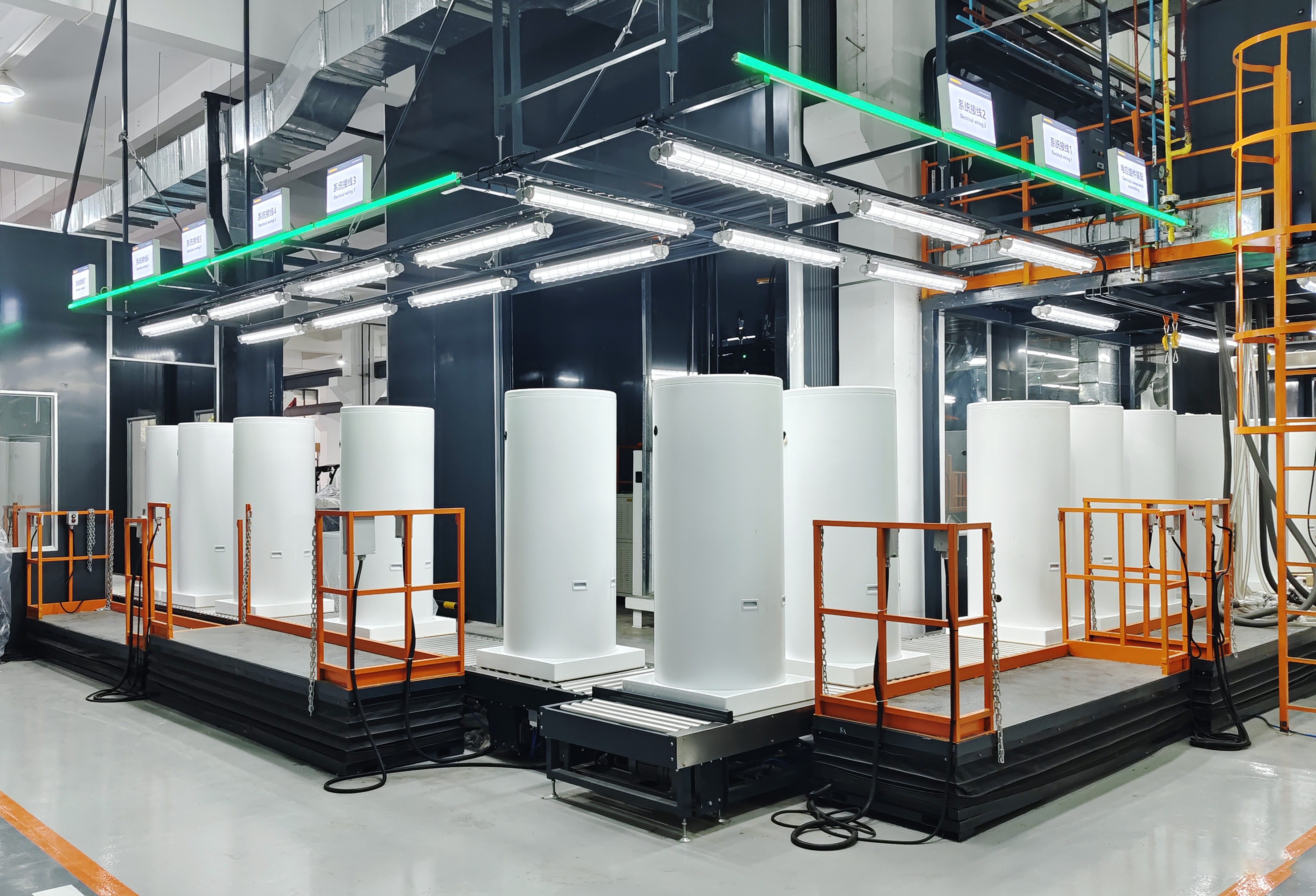 Heat pump water heaters on GOODHEAT’s automated production line with individual workstations and safety barriers
